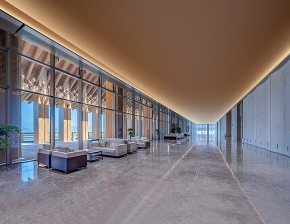 Dimmable COB LED strip installed in the ceiling of a shared public lounge, providing flicker-free 2700K light.