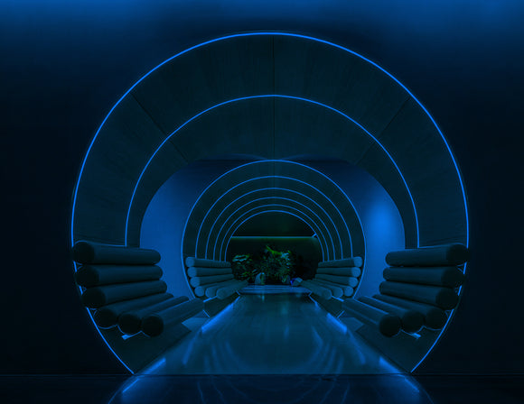 Blue Top Bend neon strip elegantly tracing the inner curve of a recessed wall channel, adding a futuristic touch to the interior space.