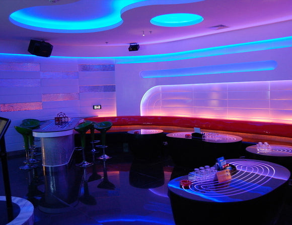 A bar lounge is decorated with RGB LED strip lights that are powered by a dimmable low voltage transformer.