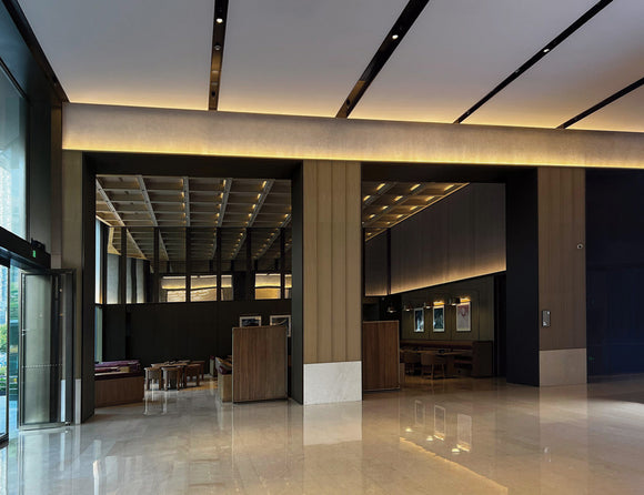 LED strip lights are used in an aluminum channel to illuminate a hallway.