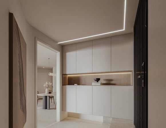 LED strip lights are used in an aluminum channel to illuminate a hallway.