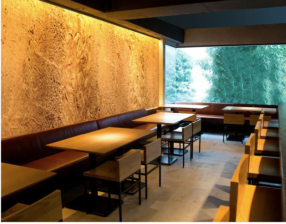 Spacious restaurant interior where a single-colored wall wash light enhances the wall and adds visual focus to the design.