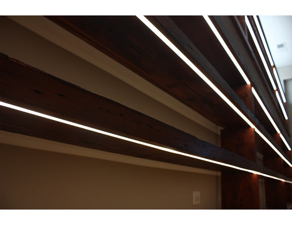 LED strip lights are used in an aluminum channel to illuminate a shelving unit.