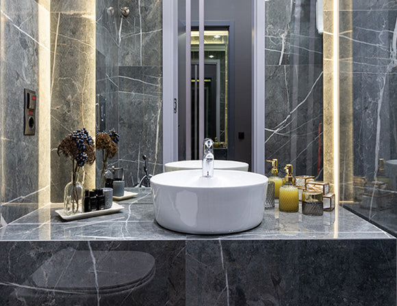 LED strip lights are used in an aluminum channel to illuminate a bathroom.