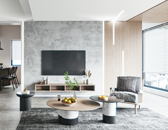 LED strip lights are used in an aluminum channel to illuminate a living room.