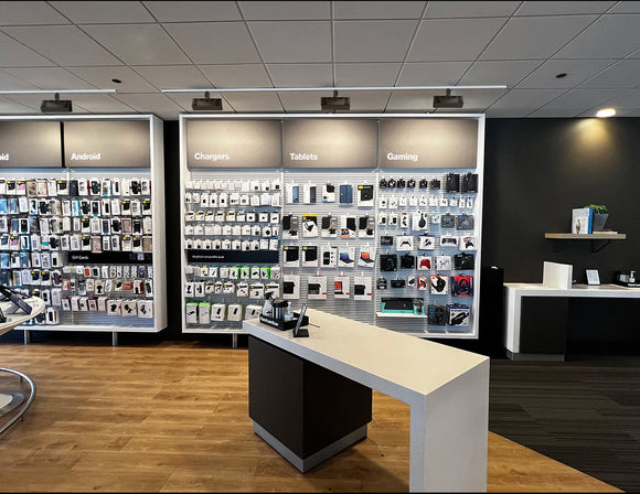 Black LED wall washer track lights illuminate a electronics store.