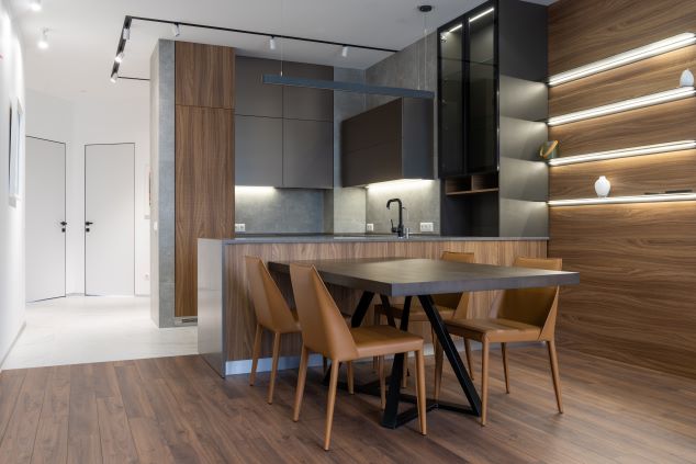 A kitchen is illuminated by multiple LED strip lights.