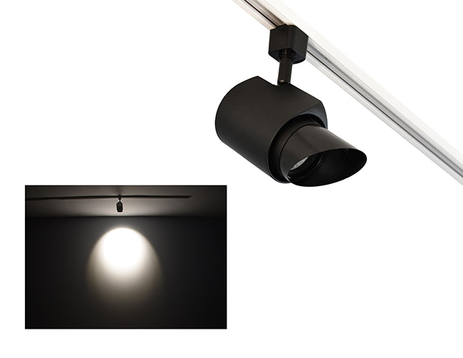 The image showcases the lighting effect produced by a track light with a ovalsnoot, revealing a stretched oval pattern bright spot on the wall targeted by the track light.