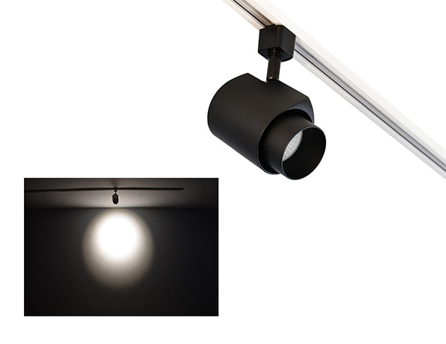 The image showcases the lighting effect produced by a track light with snoot, revealing a distinct circular bright spot on the wall targeted by the track light.