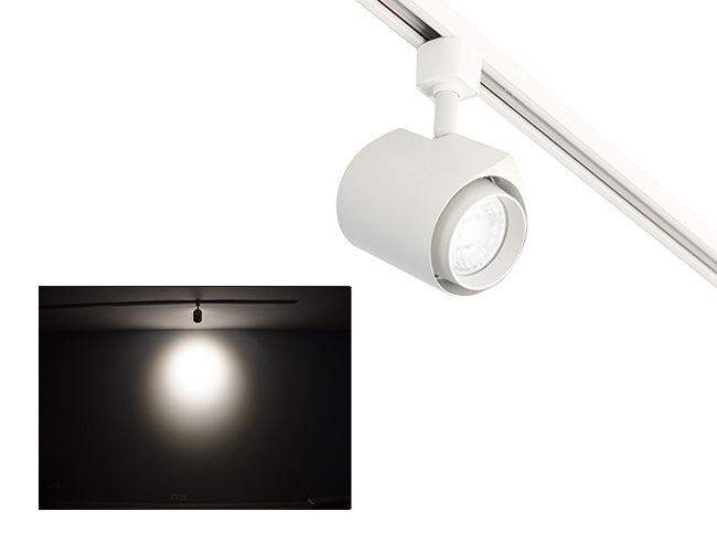 The image showcases the lighting effect produced by a white color standard track light, revealing a distinct circular bright spot on the wall targeted by the track light.