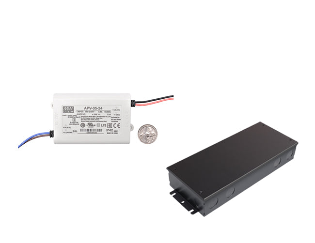 Mean Well 35W 24VDC LED driver with US quarter for size reference and black junction box for LED strip light systems.