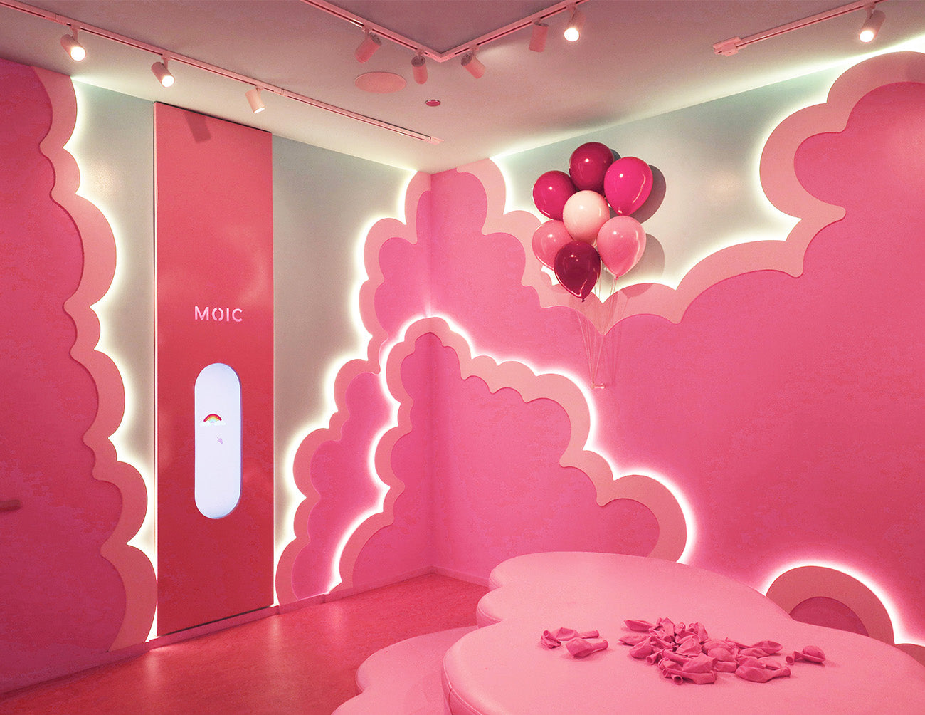 Detail of layered arch wall illuminated by neon strip lights, creating a vibrant immersive experience.