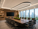 Architectural Linear Light in a custom oval configuration suspended above a modern conference table, providing elegant commercial LED lighting for executive boardrooms by GL LED US LIGHTING.