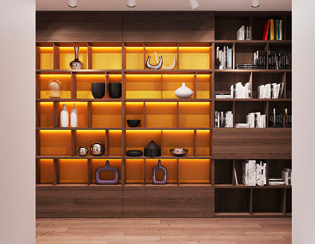 A bookshelf display is decorated with LED strip lights that are powered by a dimmable low voltage transformer.