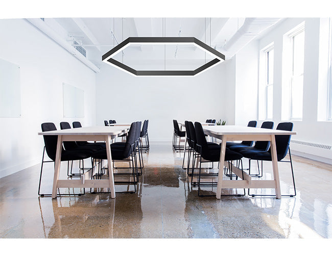 A black suspended linear light fixture formed by GL LED L8070 120° L-shaped linear light fixtures illuminate a study area.