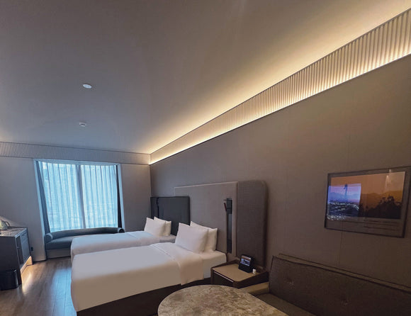 LED strip lights are used in an aluminum channel to create a unique lighting design in a hotel.