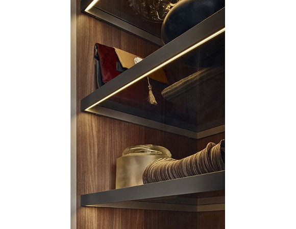 LED strip lights are used in an aluminum channel to illuminate a shelving unit.