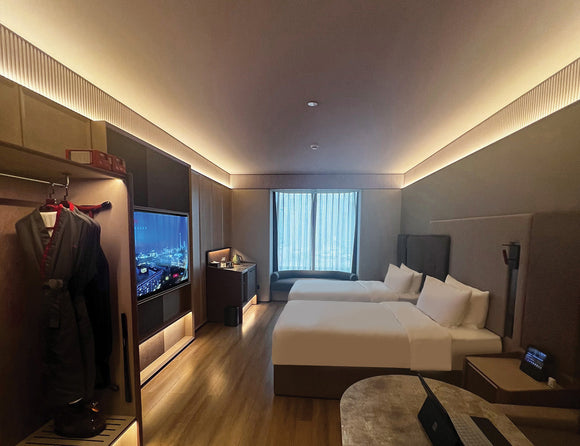LED strip lights are used in an aluminum channel to illuminate a hotel room.