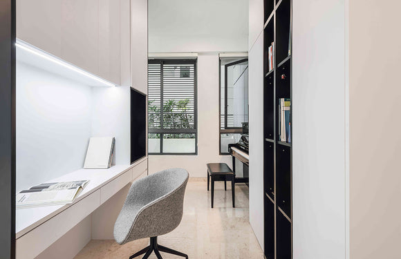 LED strip lights are used in an aluminum channel to illuminate a home office.