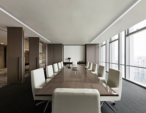 LED strip lights are used in an aluminum channel to create a unique lighting design in a conference room.