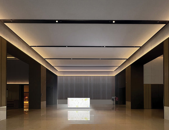 LED strip lights are used in an aluminum channel to illuminate a hallway.