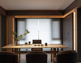 A warm toned dining room with ambient lighting is decorated with LED strip lights that are powered by a dimmable low voltage power supply.