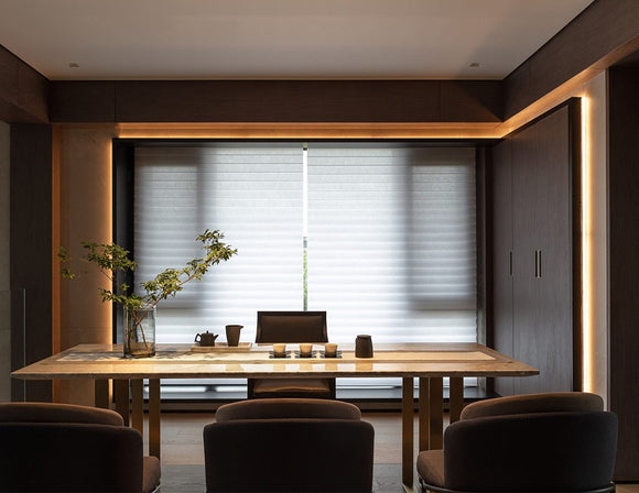 A warm toned dining room with ambient lighting is decorated with LED strip lights that are powered by a dimmable low voltage power supply.