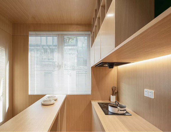 A warm toned kitchen is decorated with LED strip lights that are powered by a dimmable LED low voltage power supply. LED strip lights have many commercial and residential lighting design applications, including undercabinet light options and seamless LED strip designs.