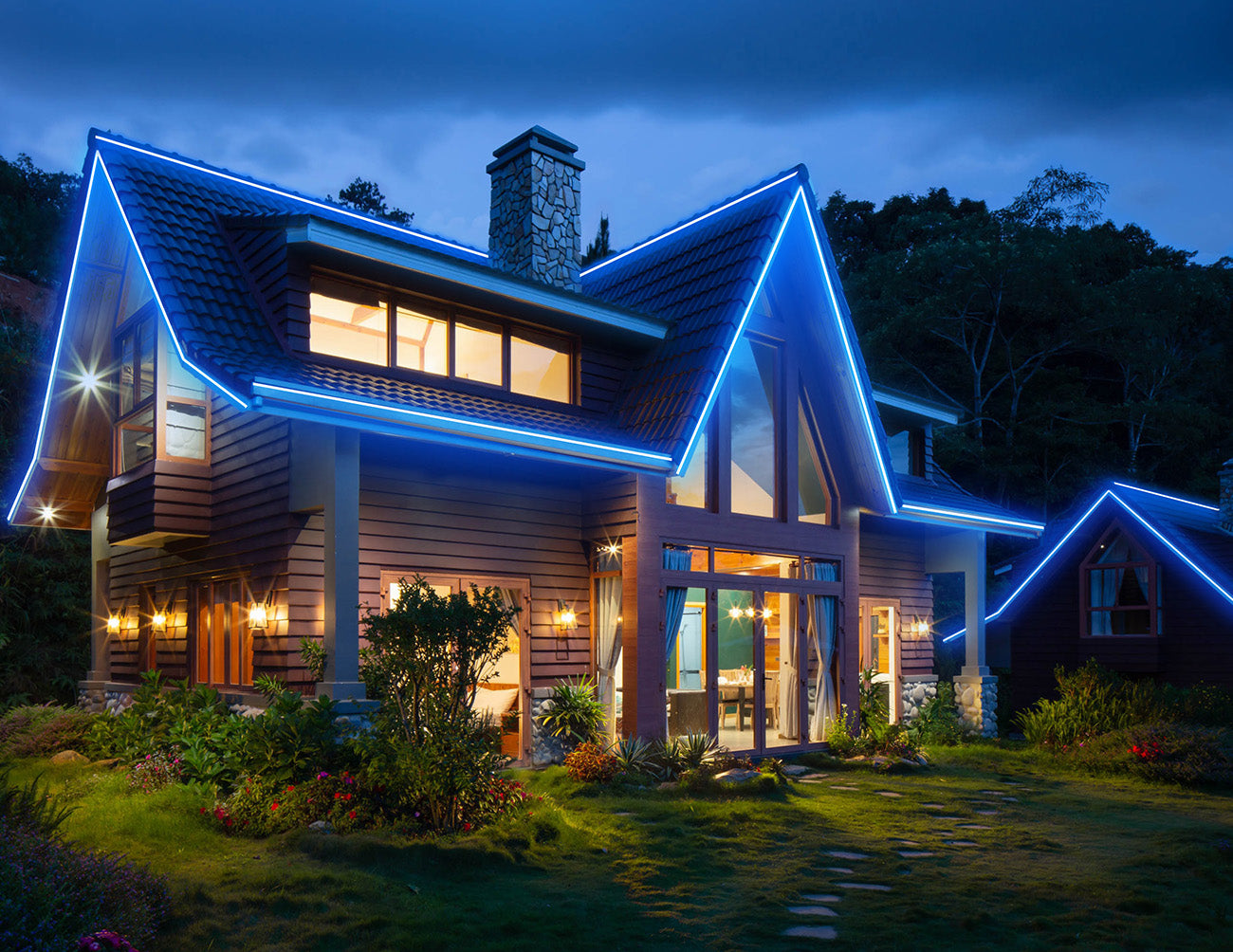 A house with a brightly lit exterior with blue LED strip lights.