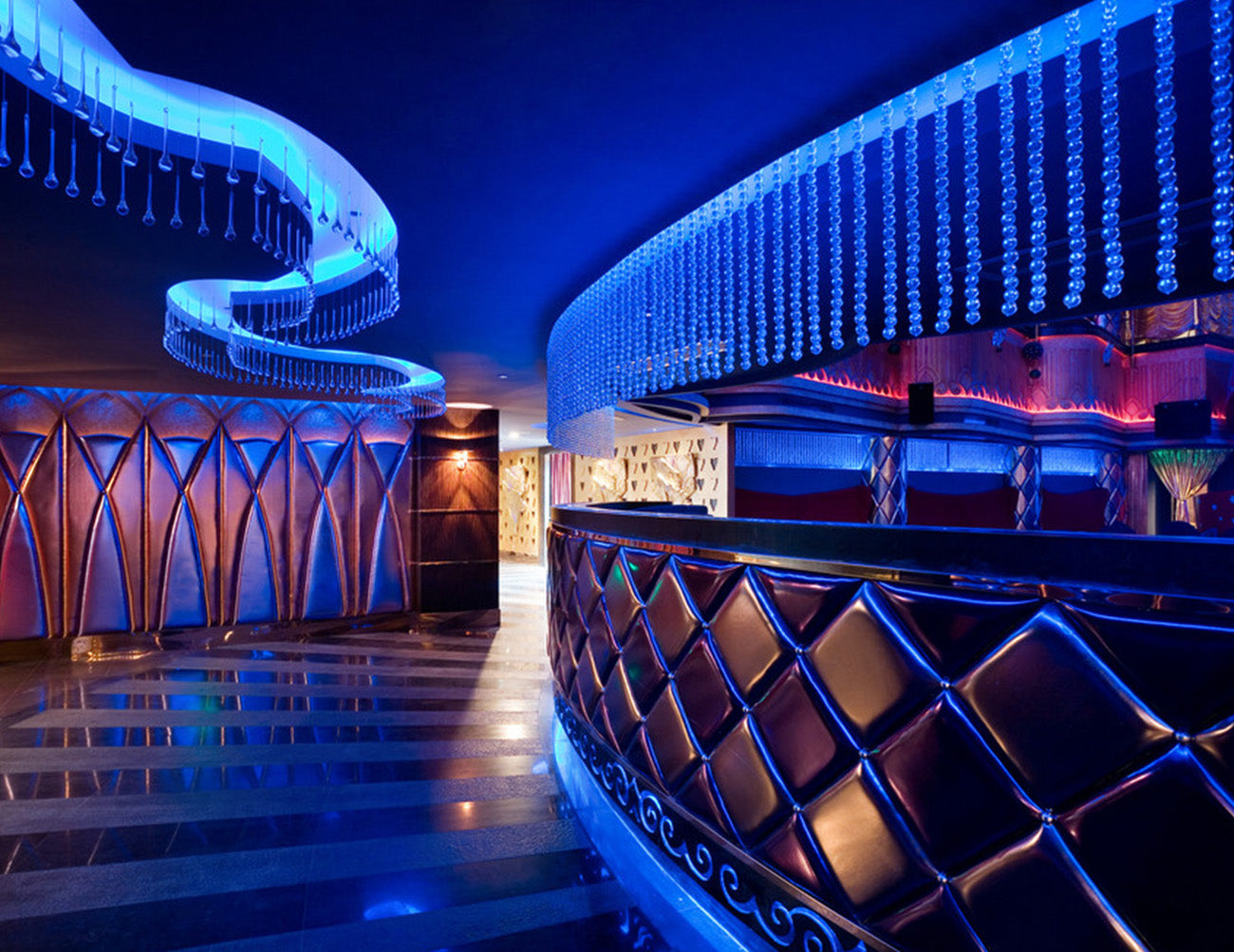 A bar hallway is decorated with RGBW color changing LED strip lights that are powered by a dimmable voltage transformer.