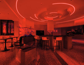 Red Side Bend neon lighting arched across the living room ceiling, delivering a bold visual statement and dramatic ambient effect.