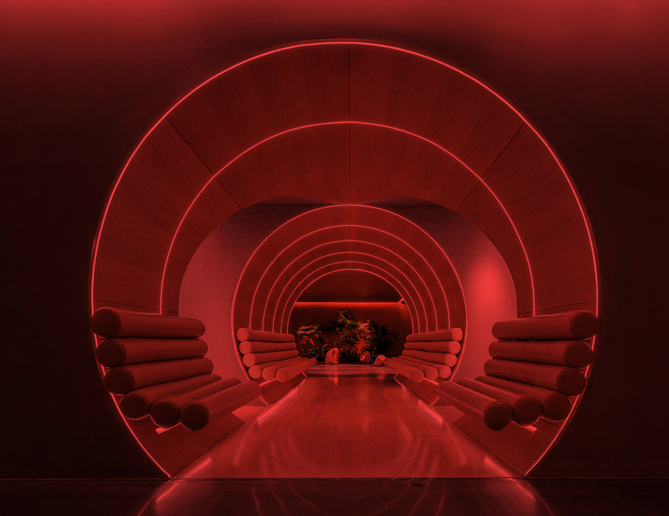 Striking red Top Bend neon lighting embedded in a curved interior wall, creating a bold architectural accent with smooth linear flow.