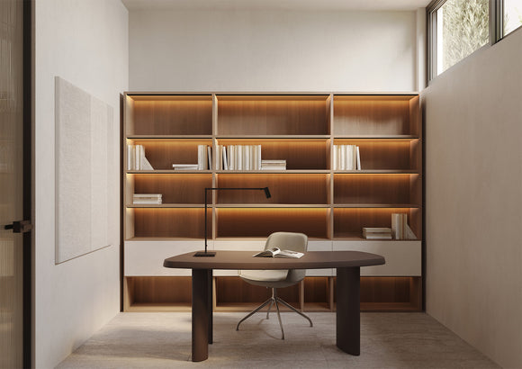 LED strip light installed in aluminum channel for shelf lighting, delivering soft and even architectural lighting in a modern home office interior.