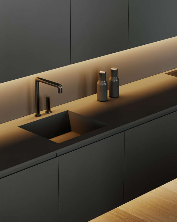 White COB LED strip light creating soft linear undercabinet lighting in a modern kitchen sink area, architectural lighting application by GL LED US LIGHTING.
