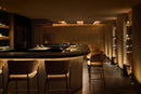 White COB LED strip light integrated into a modern restaurant bar creating warm linear architectural lighting along the counter and wall panels, project by GL LED US LIGHTING.
