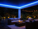 RGB IP65 LED strip light installed in outdoor patio ceiling cove, providing color-changing linear lighting for ambient architectural illumination in semi-outdoor environments.