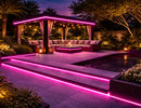RGBW IP67 LED strip light installed along poolside deck, pergola roof, and seating area, creating pink linear lighting for outdoor architectural and landscape lighting design.