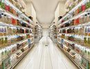 Magnetic Shelf Power Distribution Track installed in retail shelving, providing continuous power distribution and uniform LED lighting throughout a supermarket aisle.