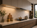 Modern open-concept kitchen featuring integrated Undercabinet Lighting beneath wall cabinets, providing uniform countertop illumination and enhancing the architectural design of the space.