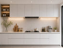 Modern white kitchen featuring integrated Undercabinet Lighting, providing uniform task illumination across the countertop while enhancing the clean architectural design of the cabinetry.
