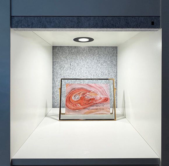 Recessed LED Puck Light installed in a display cabinet, providing focused overhead lighting for merchandise and retail display applications.