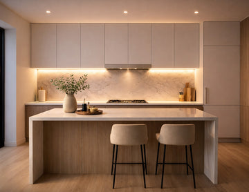 Recessed undercabinet LED strip lighting integrated beneath modern minimalist kitchen cabinets, providing uniform 3000K warm white linear task illumination for residential architectural lighting projects