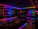 RGB SPI LED Strip - Digital Color-Chasing LED Tape Light integrated into a modern entertainment room with ceiling, media wall and bar accent lighting.