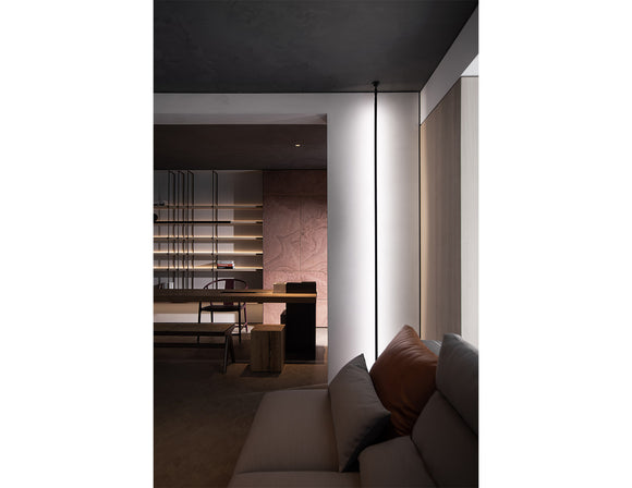 Round wall-mounted LED strip light using black aluminum channel, creating indirect wall wash lighting in a modern architectural interior