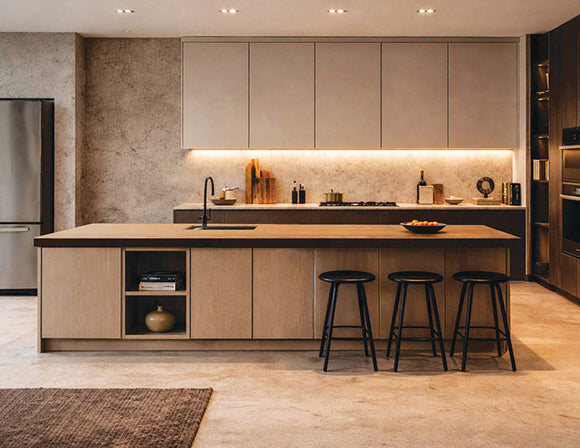 Warm white Surface Mount Under Cabinet Light installed beneath modern kitchen cabinets, delivering continuous and shadow-free illumination across the backsplash and countertop. The seamless linear lighting enhances task visibility while complementing the minimalist cabinetry and spacious kitchen island, making it an ideal lighting solution for residential and commercial architectural kitchen projects by GL LED US LIGHTING.