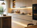 Elegant modern kitchen illuminated by a Surface Mount Under Cabinet Light, creating continuous warm white task lighting beneath the upper cabinets and along the toe kick for a clean, layered architectural lighting effect. The seamless illumination enhances countertop visibility, highlights premium cabinetry, and provides an ideal lighting solution for residential and commercial kitchen applications by GL LED US LIGHTING.