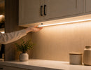 Wired Independent Control - Wave Sensor Dimmer installed beneath a cabinet, enabling convenient hand wave activation and control of integrated under cabinet lighting for architectural interior applications.