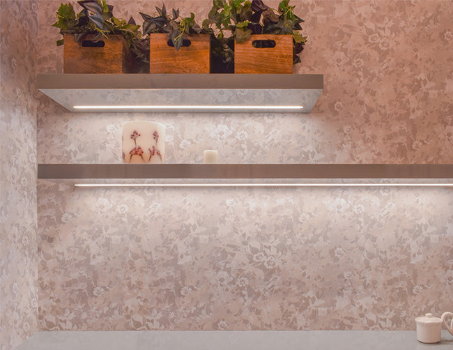 LED strip light fixtures using slim shallow recess ES 2309 are installed under shelves holding flowers and cups.