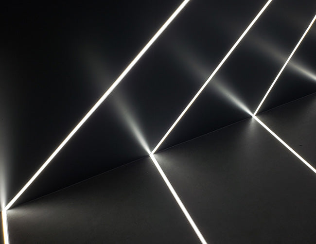 LED strip light fixtures using slim square ES 1715 channels are installed on the wall and ceiling to create straight and uniform lighting effects.