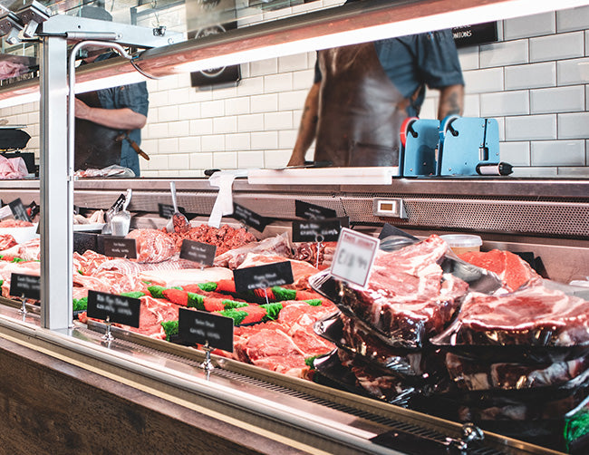 A meat display is decorated with LED strip lights that have specialized colors for enhancing the appeal of fresh meat products.